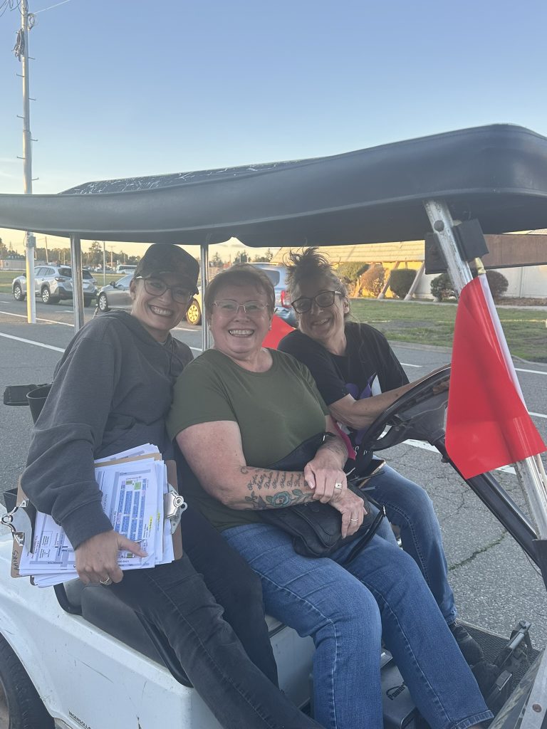 Volunteers Lindsay Calegari, her mom, and coordinator Laurie Banks tool around to check on free shuttle service